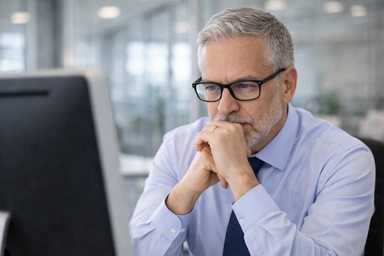 Billing support professional reviewing work at a computer