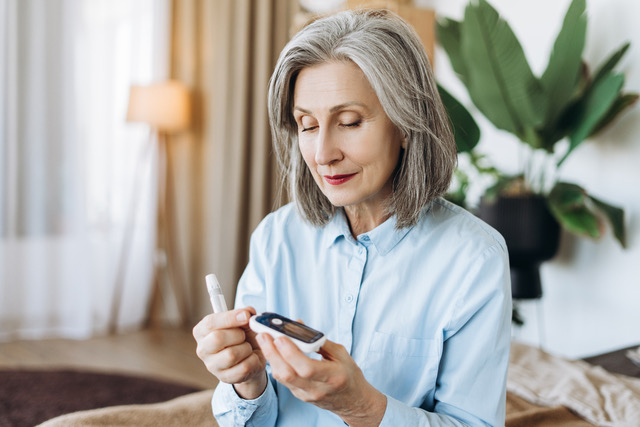 Woman checking a glucose monitor.